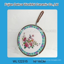 Classical flower design ceramic trivet with brown rope for hanging